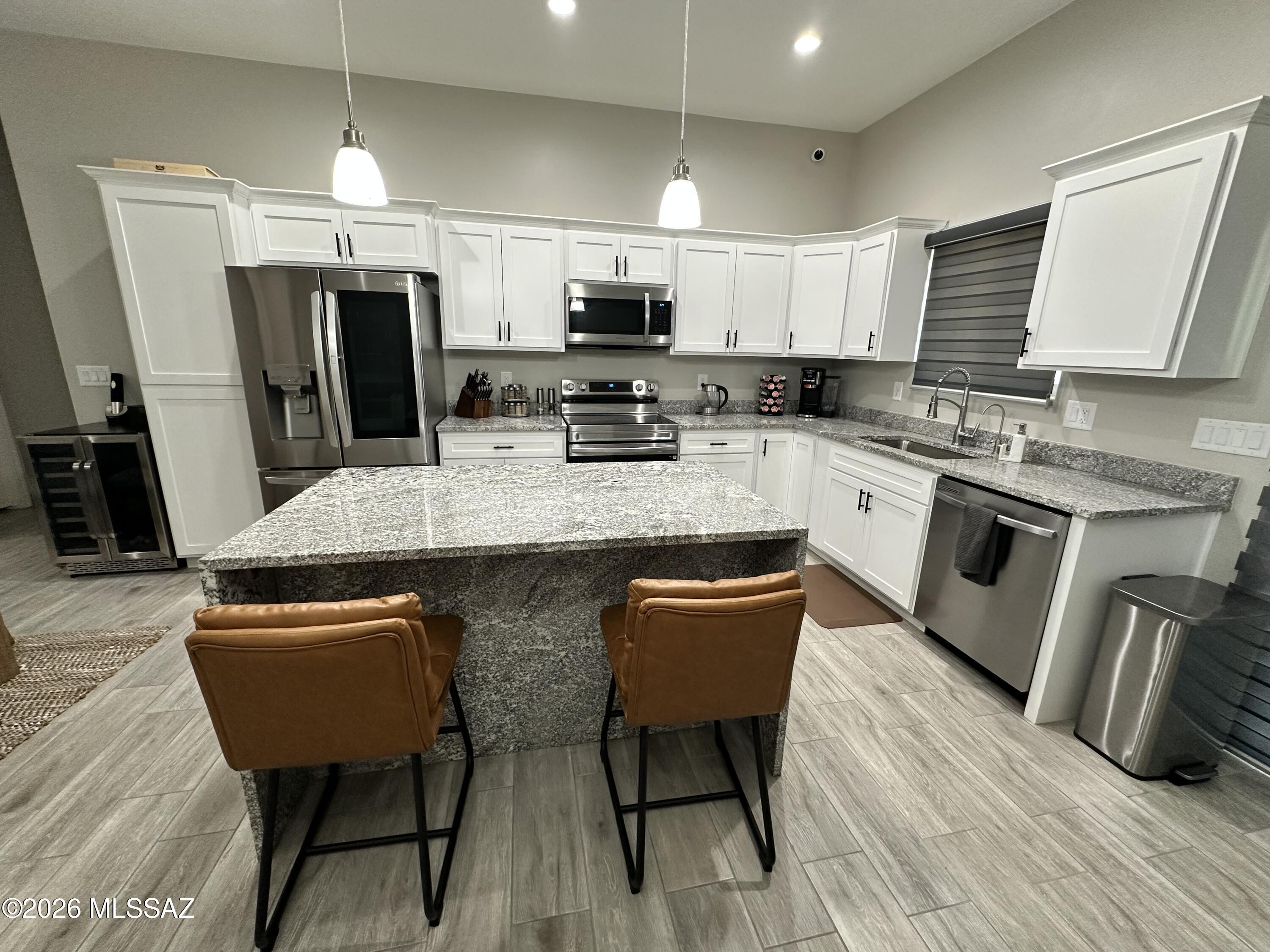 117 Ver Patria Rio Rico, AZ 85648 - Photo 4 of 28 a kitchen with stainless steel appliances granite countertop a sink dishwasher a refrigerator a stove a microwave oven with granite countertops and cabinets