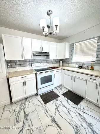 a kitchen with a sink stove and cabinets