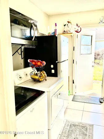 a kitchen with a sink and refrigerator