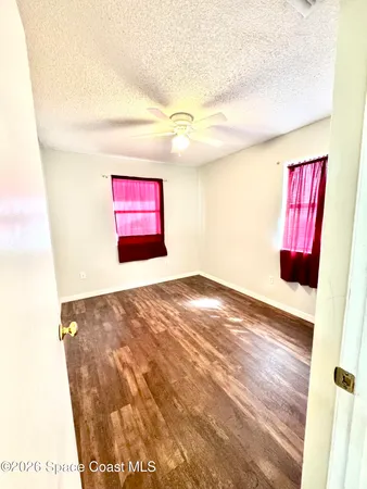 a view of a room with window and wooden floor
