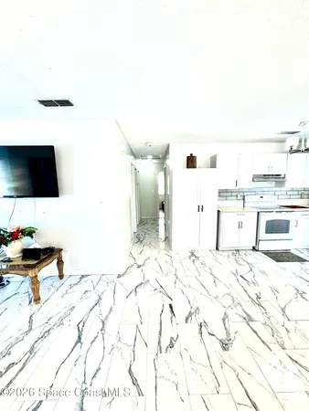 a view of a bedroom with a bed and tv