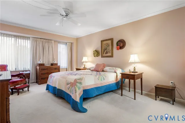 a spacious bedroom with a bed and a chandelier