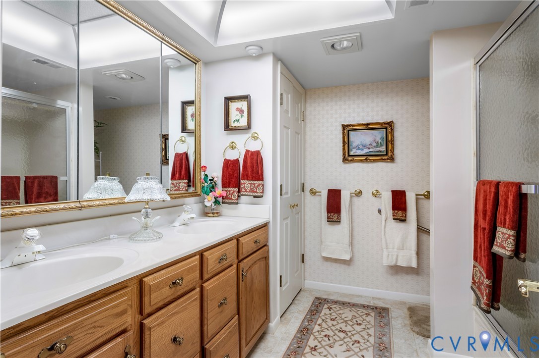 2956 Hathaway Road, Unit U301 Richmond, VA 23225 - Photo 22 of 36 a bathroom with a double vanity sink and a mirror