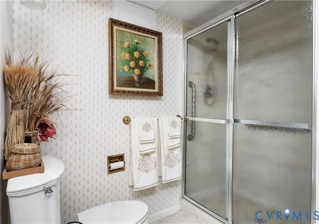 a bathroom with a toilet sink and shower