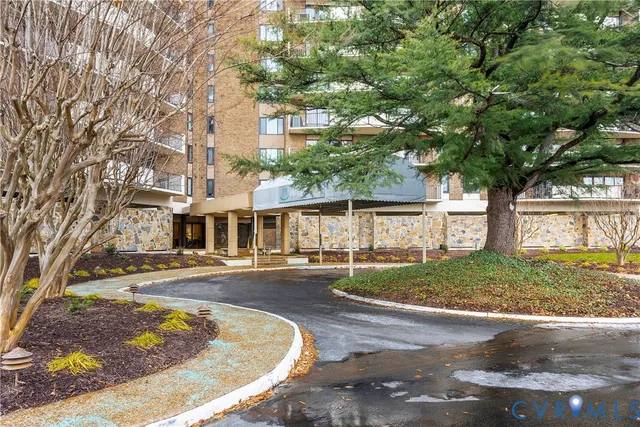 a view of a big house with a tree in the background