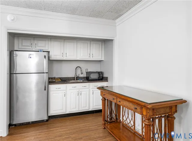 a kitchen with stainless steel appliances granite countertop a refrigerator a stove and a sink