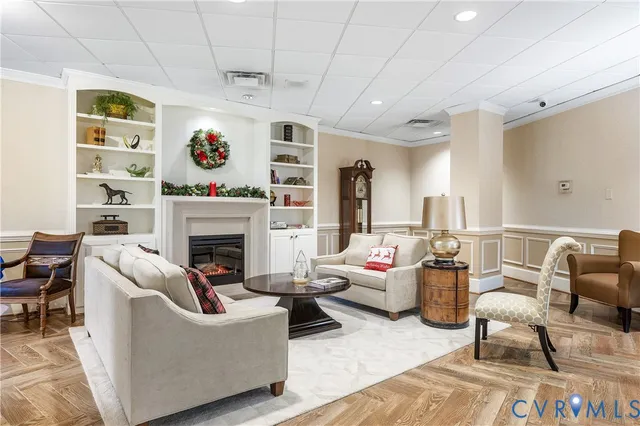 a living room with furniture and a fireplace