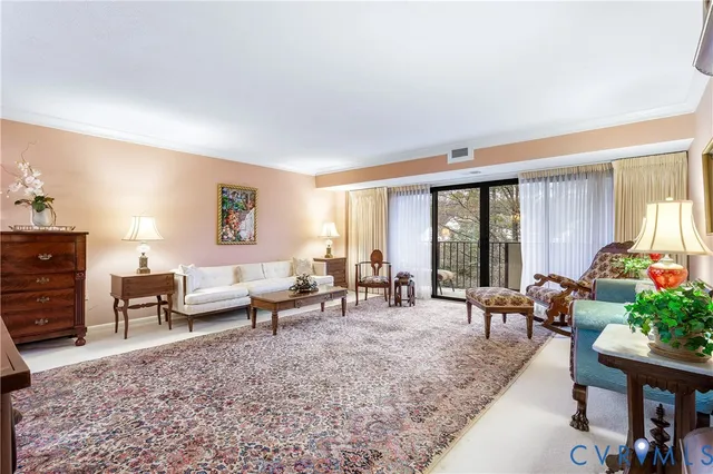 a living room with furniture and large windows