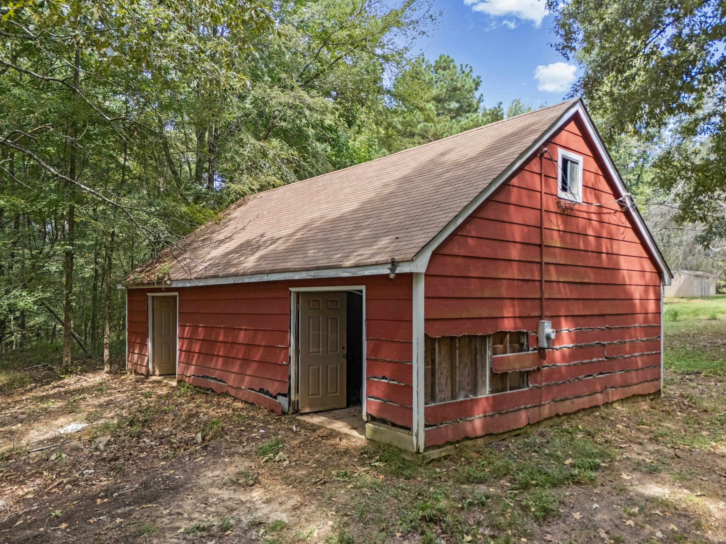 779 Strickland Road Coldwater, MS 38618 - Photo 37 of 40 Red siding structure with a gable roof