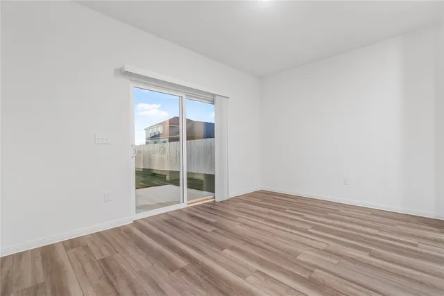 a view of kitchen appliances and wooden floor