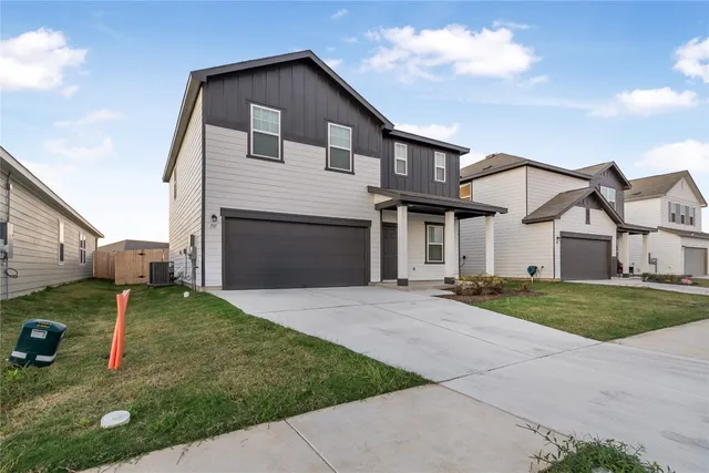 a front view of a house with a yard and garage