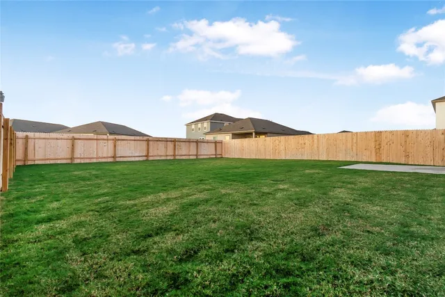 a view of a big house with a big yard and large trees