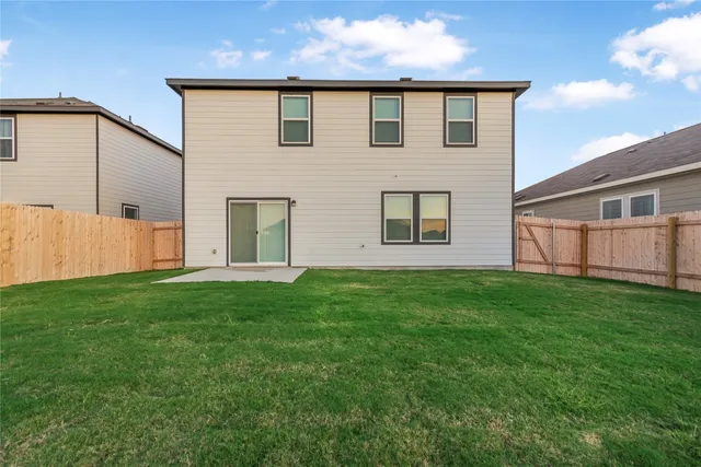 a view of a backyard with plants and a garden