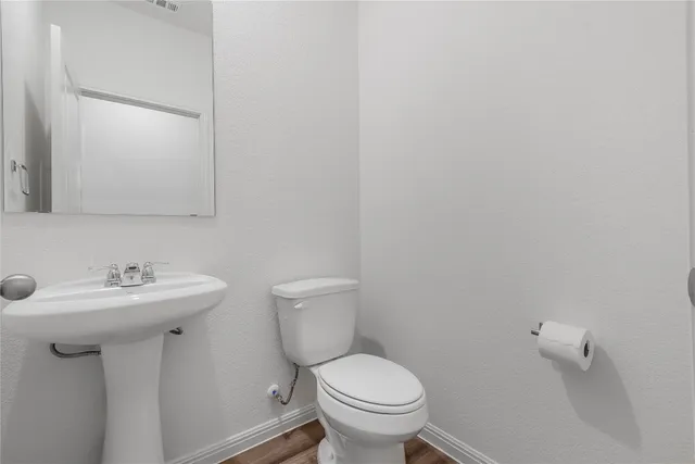 a bathroom with a sink toilet and a mirror