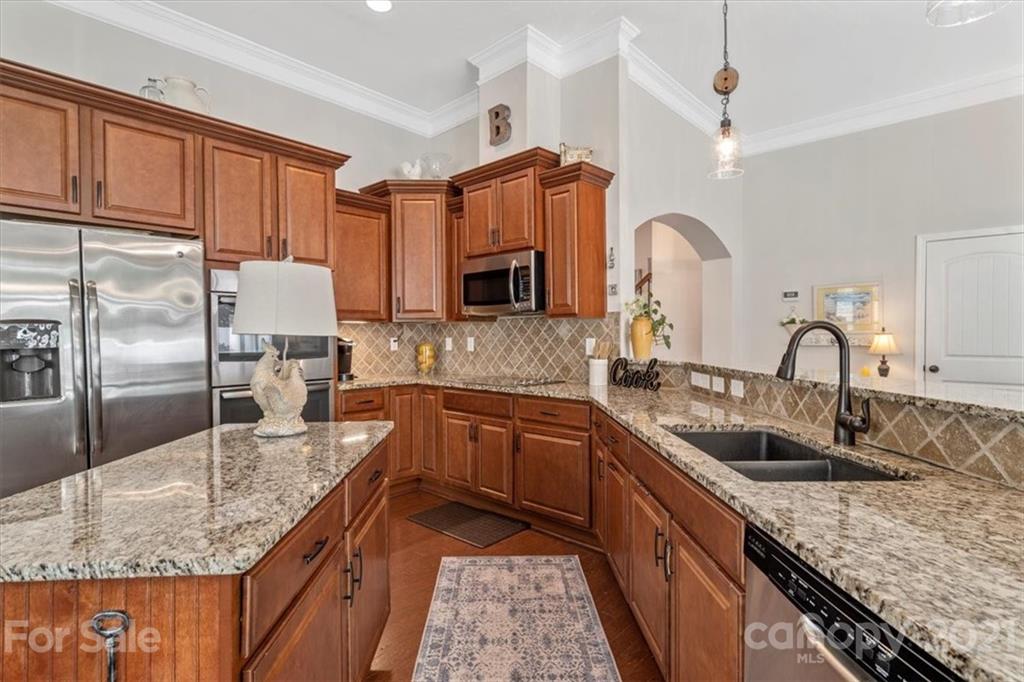 79067 Ridgehaven Road Lancaster, SC 29720 - Photo 14 of 38 a kitchen with granite countertop a sink stove and refrigerator