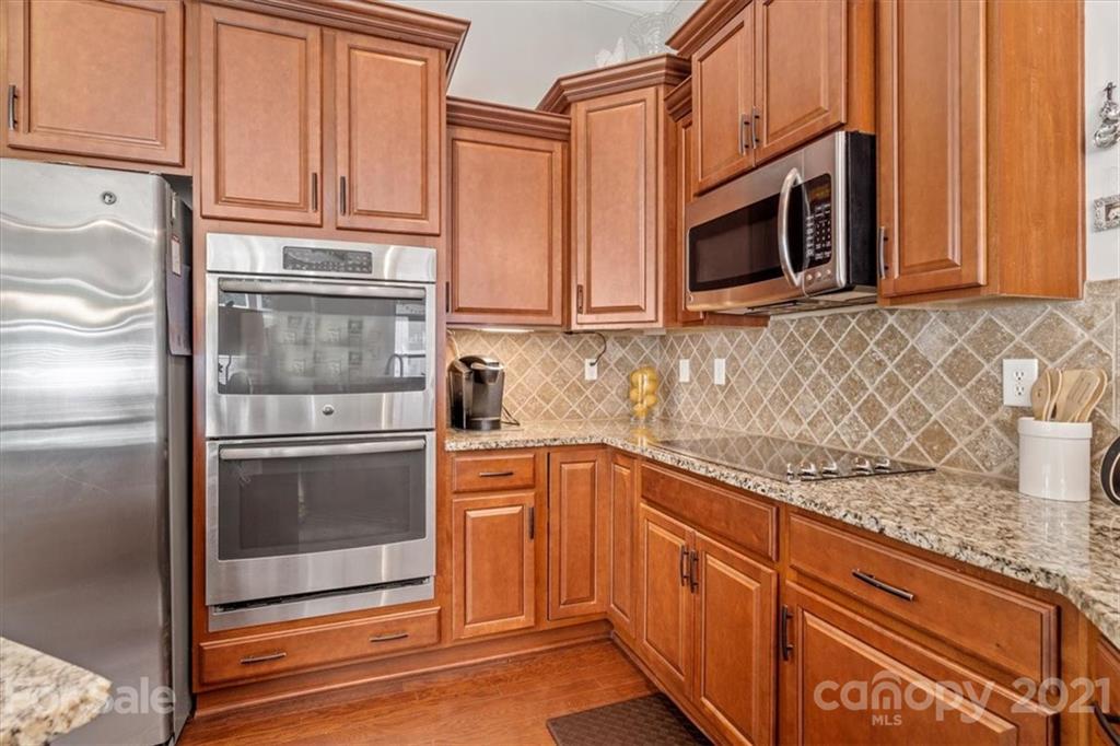 79067 Ridgehaven Road Lancaster, SC 29720 - Photo 15 of 38 a kitchen with stainless steel appliances granite countertop a refrigerator and cabinets
