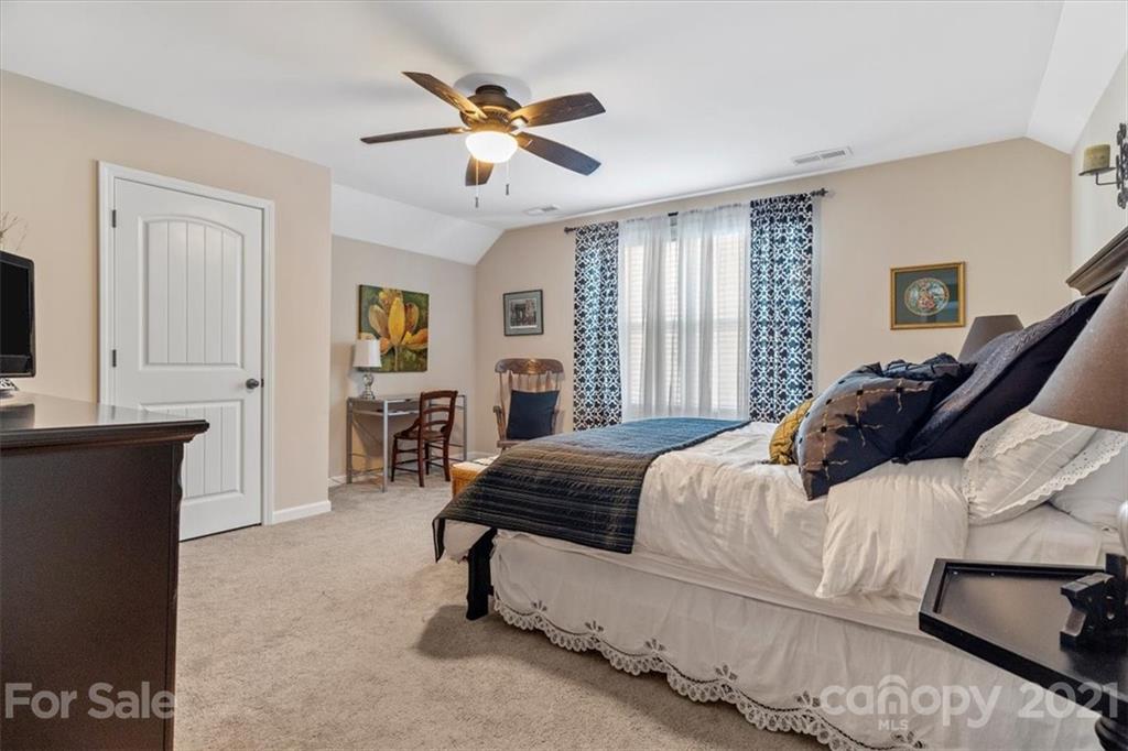 79067 Ridgehaven Road Lancaster, SC 29720 - Photo 23 of 38 a bedroom with a large bed and a chandelier