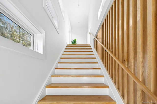 a bathroom with a granite countertop shower a sink and a mirror