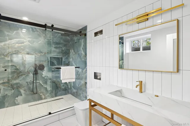 a view of an empty room with a window and a kitchen