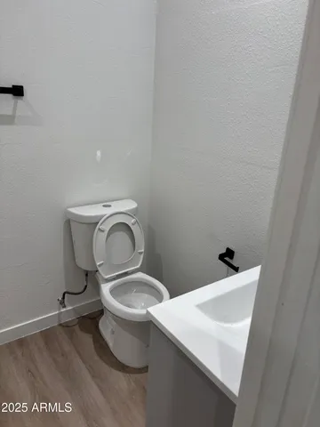 a bathroom with a sink toilet and a mirror