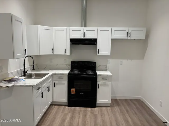 a kitchen with a sink dishwasher a stove and a refrigerator
