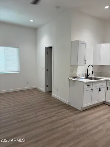 a view of a kitchen with wooden floor