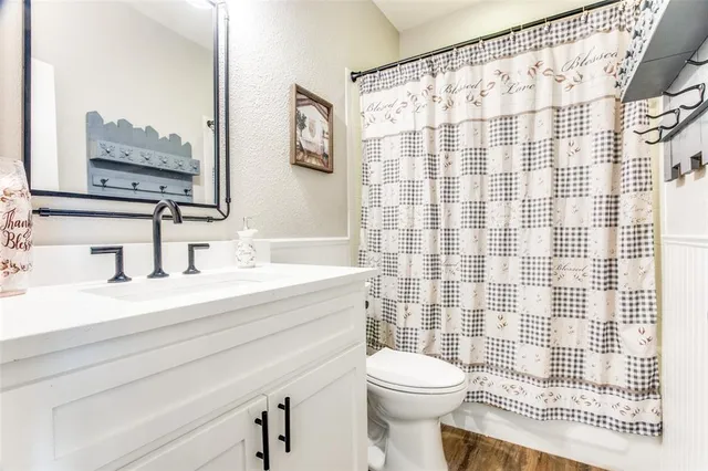 a bedroom with a bed a rug and wooden floor