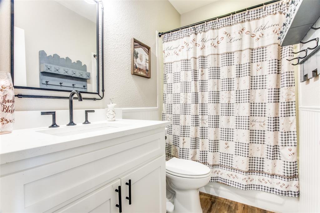 8060 Watson Road Lantana, TX 76226 - Photo 11 of 16 a bathroom with a sink a toilet and shower