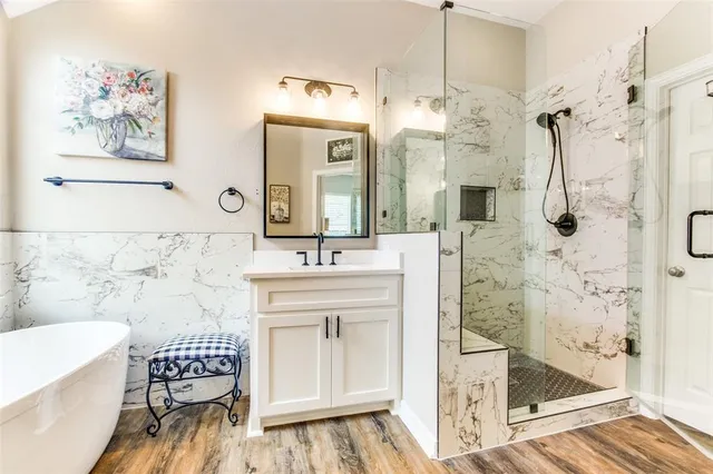 a bath room with a double vanity sink and a mirror