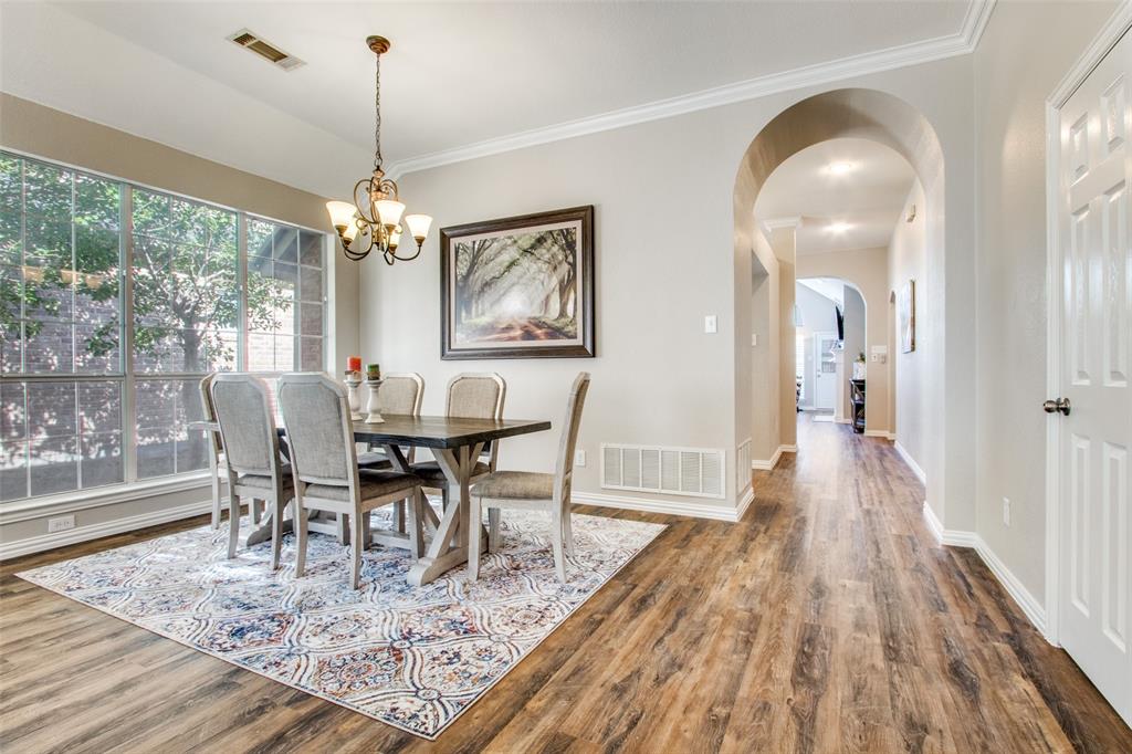 8060 Watson Road Lantana, TX 76226 - Photo 4 of 16 a view of a dining room with furniture wooden floor and chandelier