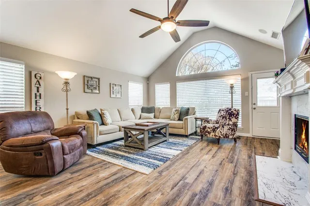 a living room with furniture a chandelier and a large window