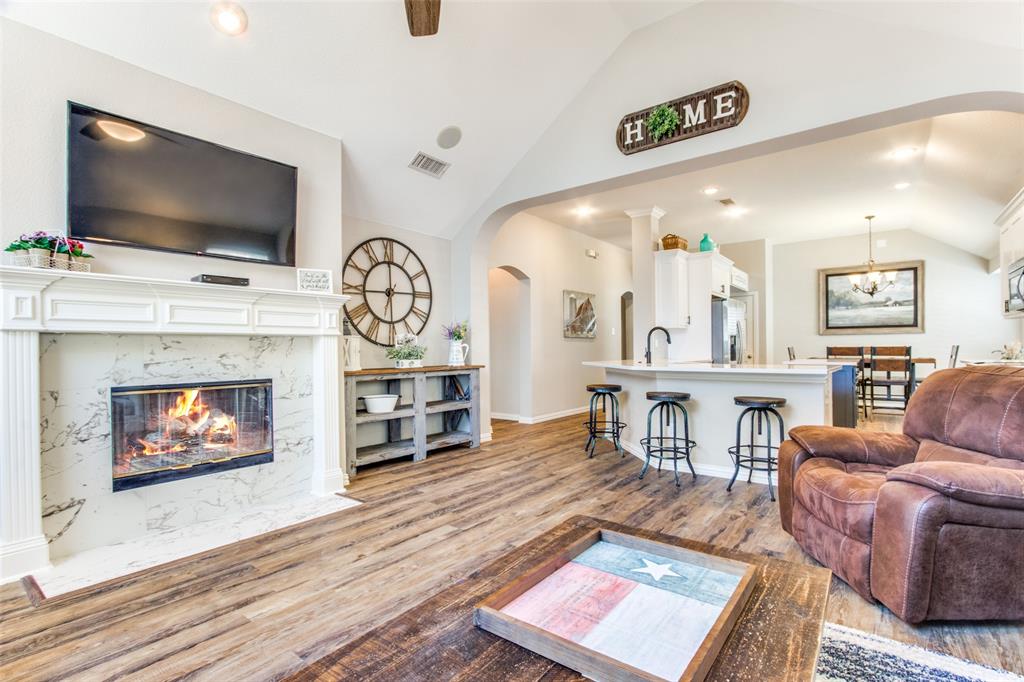 8060 Watson Road Lantana, TX 76226 - Photo 6 of 16 a living room with furniture a flat screen tv and a fireplace
