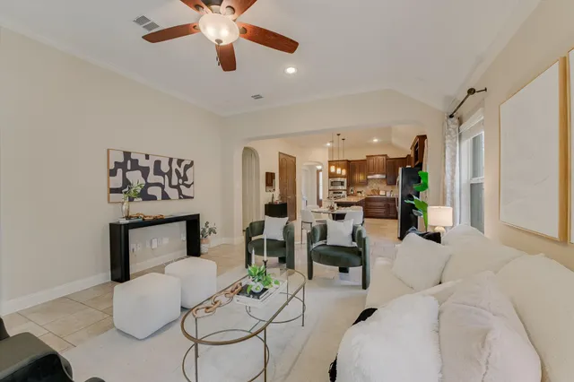 a living room with furniture and a chandelier