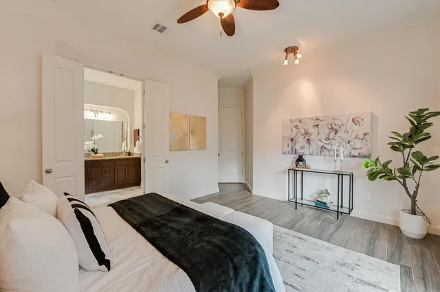 a bedroom with a bed and a chandelier