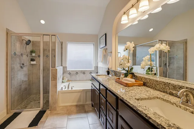 a bathroom with a granite countertop sink mirror and shower