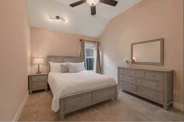 a bedroom with a bed and a dresser in it