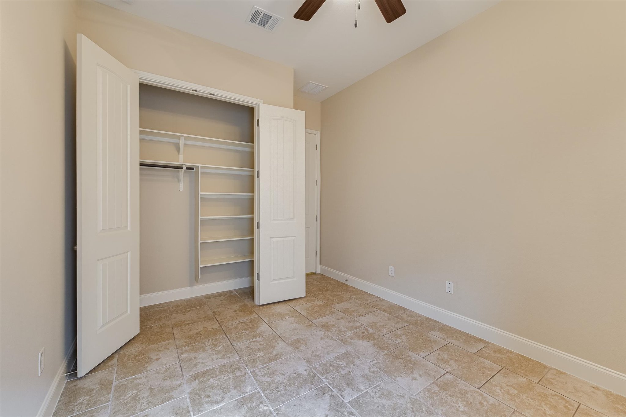 13017 Hymeadow Circle Austin, TX 78729 - Photo 23 of 32 an empty room with closet and windows