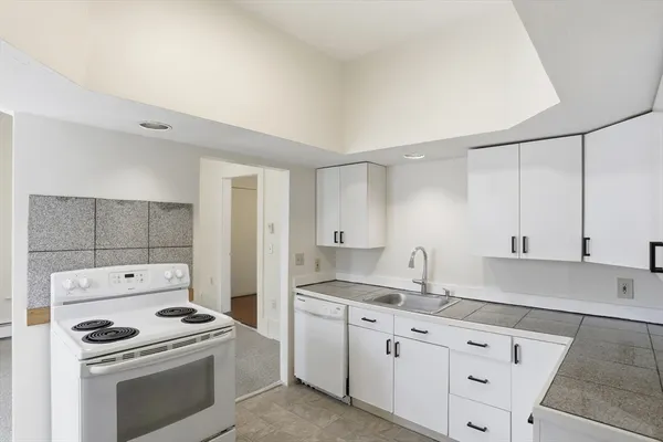a kitchen with granite countertop cabinets stainless steel appliances and a sink