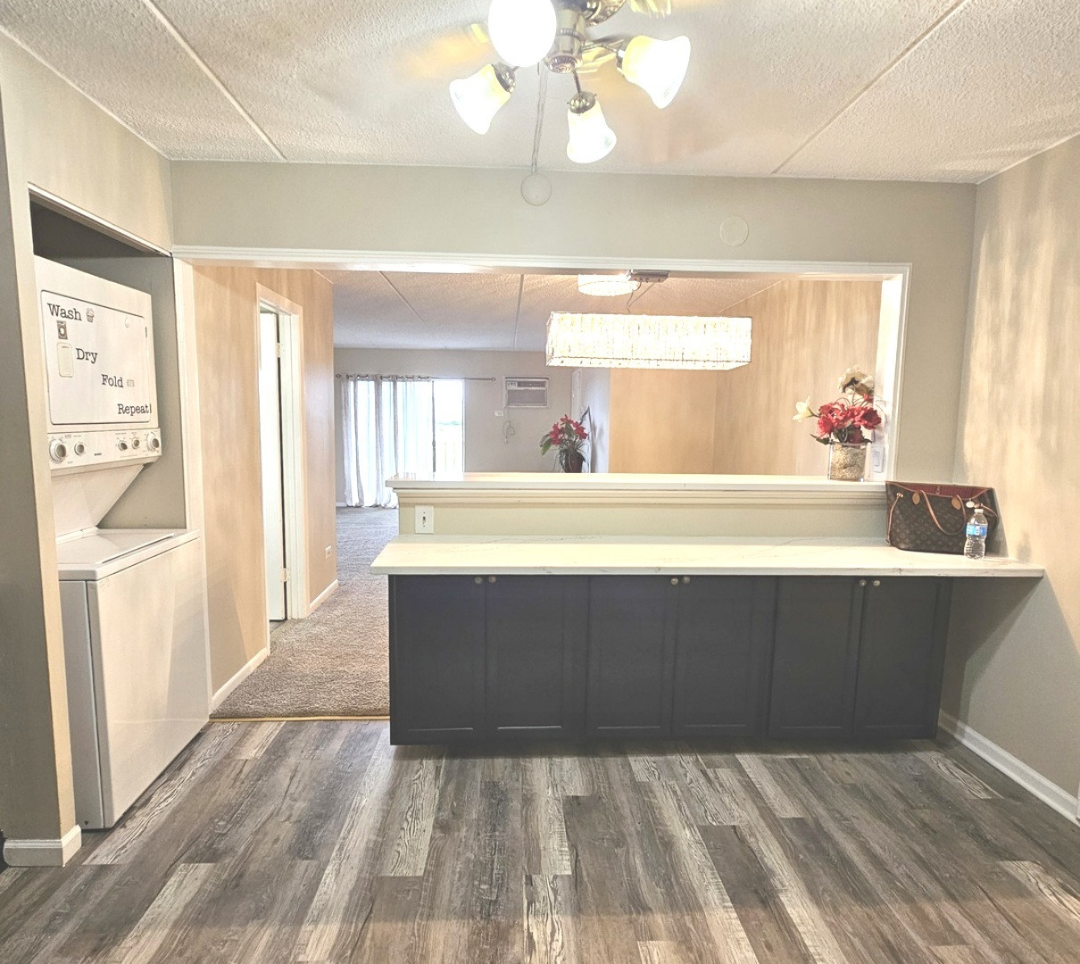 943 North Rohlwing Road, Unit 101H Addison, IL 60101 - Photo 3 of 12 a room with a sink cabinets and wooden floor