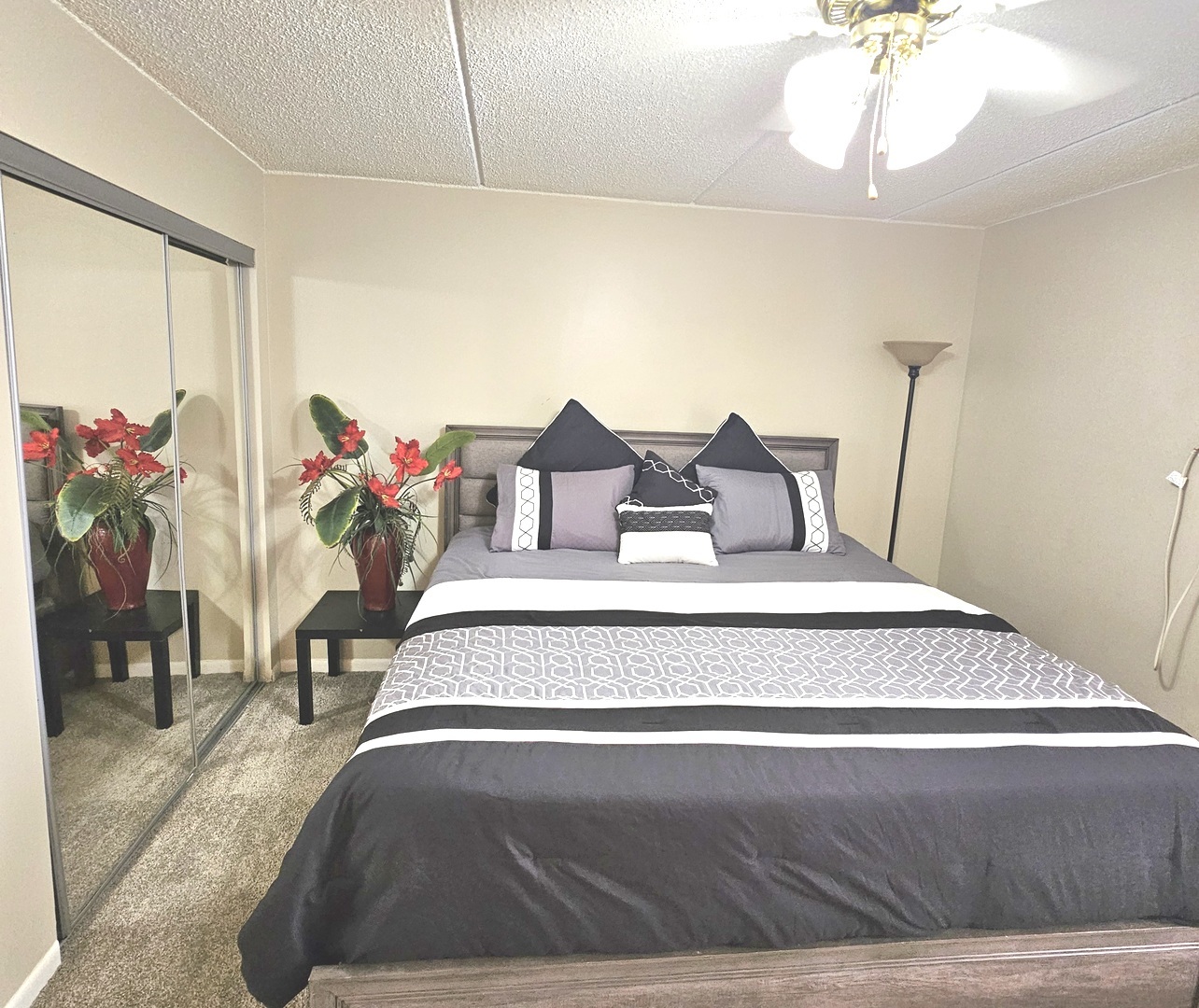 943 North Rohlwing Road, Unit 101H Addison, IL 60101 - Photo 5 of 12 a spacious bedroom with a bed a chandelier and a window