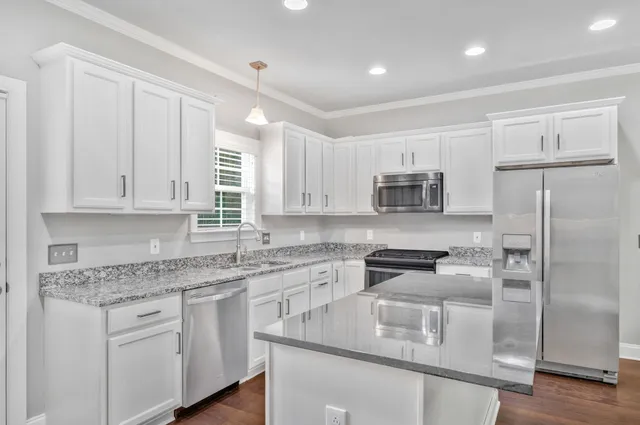 a view of a kitchen counter space and wooden floor