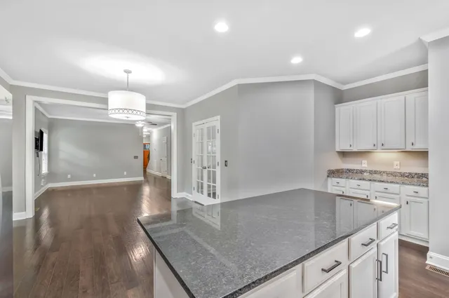 a view of an empty room with a window and a ceiling fan