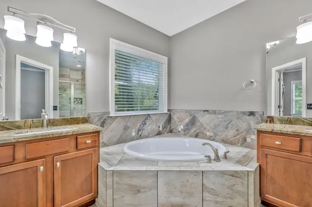 a bath tub sitting in a bathroom next to a window