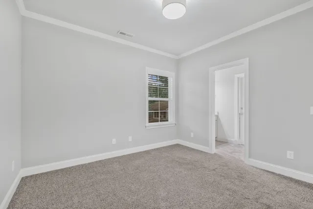 a view of an empty room and closet area