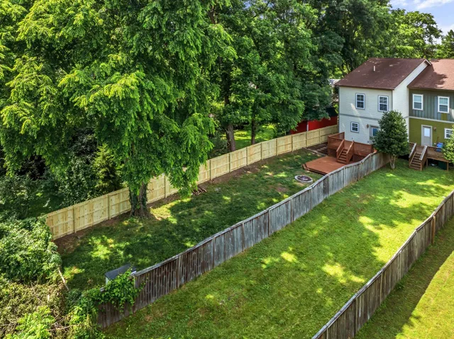 a view of house with garden space and sitting area