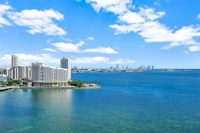 a view of residential houses with outdoor space and river