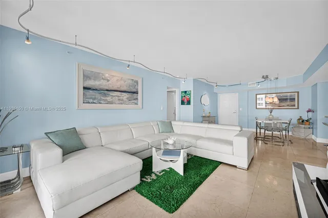 a living room with furniture a flat screen tv and a large window