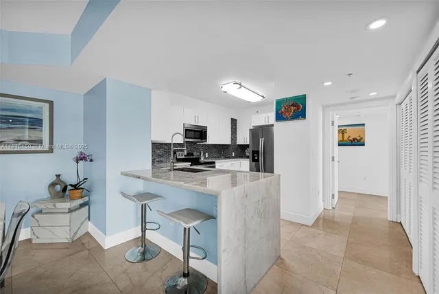 a view of a chairs and table in patio with a barbeque