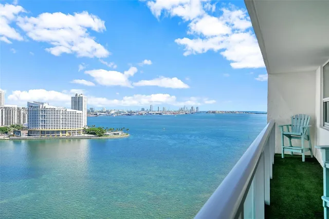 a bedroom with a large bed and a flat tv screen