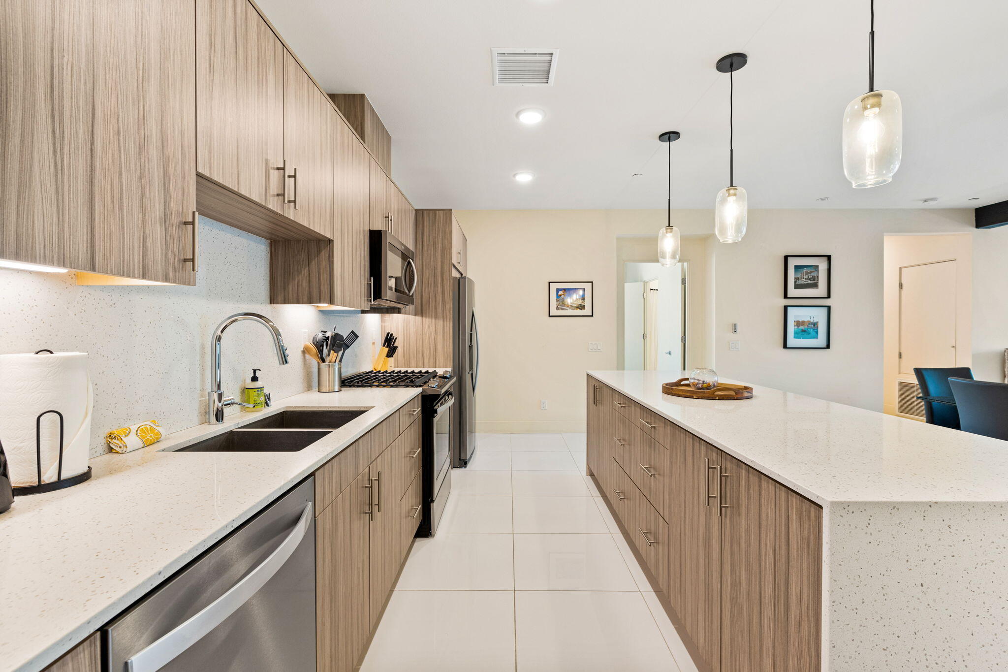 191 The River Palm Springs, CA 92262 - Photo 12 of 39 a kitchen with stainless steel appliances a sink stove and cabinets